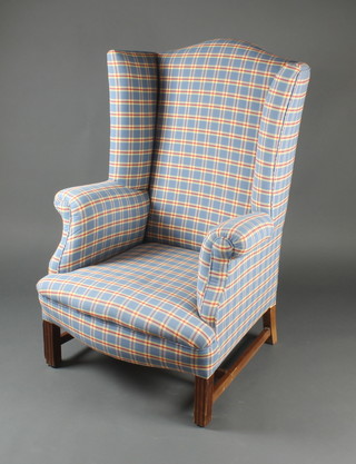 A Georgian style wing armchair upholstered in blue and red chequered material 