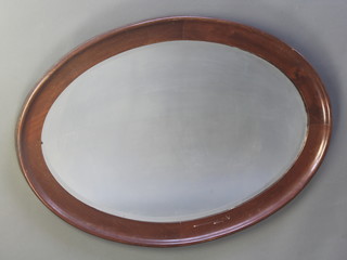 An oval bevelled plate wall mirror contained in a mahogany frame 28"h x 40"w 