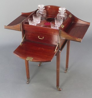 An Edwardian mahogany decanter/cigar cabinet of arched form, the hinged lid revealing a well fitted interior with 2 etched glass decanters, 4 associated stoppers and cigar/cigarette drawer, raised on square tapering supports 31"h x 14 1/2" x 14 1/2"  