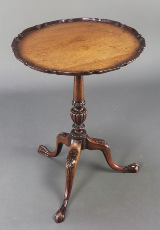 A Chippendale style mahogany snap top wine table with pie crust edge raised on a pillar turned column, egg and claw feet 27"h x 20 1/2"