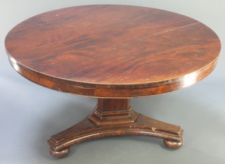 A Victorian circular snap top breakfast table raised on a chamfered column with triform base 28"h x 60" diam. 
