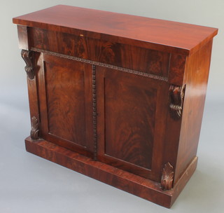 A Victorian mahogany chiffonier fitted 1 long drawer above a cupboard enclosed by panelled doors with vitruvian scrolls to the sides, raised on a platform base 34"h x 34 1/2"w x 16 1/2"d 