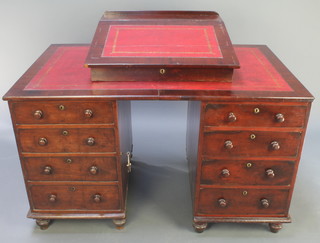 A Victorian mahogany Dickens style desk, the associated slope with hinged lid inset a red writing surface, the pedestals fitted dummy drawers to one side and 4 drawers to the other, raised on bun feet 37"h x 50"w x 30 1/2" 