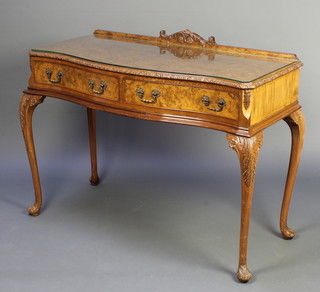 In the manner of Hilly, a Queen Anne style carved figured walnut side table with raised back fitted long drawers, with plate glass top, raised on cabriole supports 37"h x 48"w x 20"
