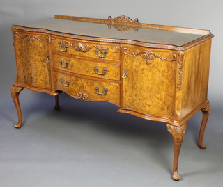 In the manner of Hilly, a Queen Anne style figured walnut bow front sideboard with raised back, fitted 3 long drawers flanked by a pair of cupboards, with a plate glass top,  raised on cabriole supports 42"h x 65 1/2"w x 25"d 
