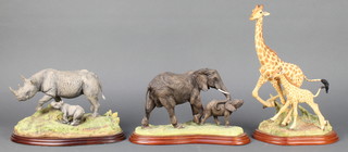 A Border Fine Arts Wild World figure of an elephant with calf A5409 10", another Giraffe A5407 12" and a Wild World Rhino and baby A410 10"  