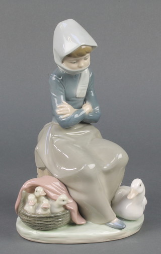 A Lladro group of a seated lady with geese, boxed 8" 