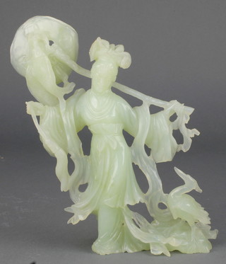 A Chinese carved jadeite figure of a fisher woman with hardwood stand 8 1/2" 