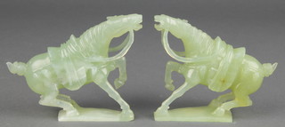A pair of Chinese carved jadeite figures of horses on wooden stands, boxed 4" 