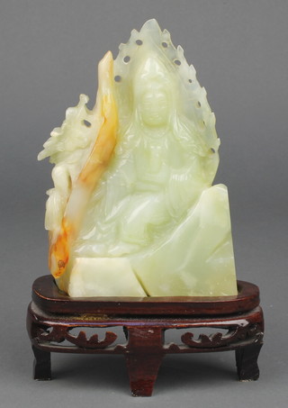 A Chinese carved jadeite figure of a deity and dragon on a hardwood stand 5 1/2" 