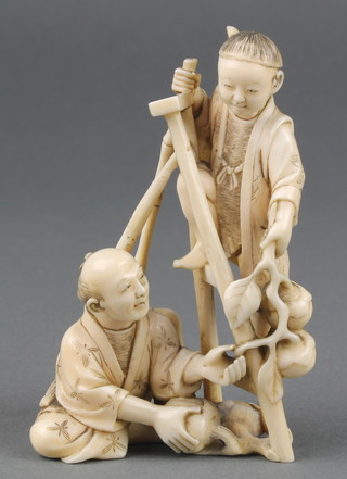 A Japanese Meiji period carved ivory okimono of a seated man and another man climbing a ladder carrying peaches 4" 