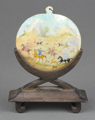 An early 20th Century Persian painted mother of pearl pendant depicting a hunting scene 2 1/2" 