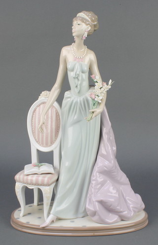 A Lladro figure of a lady standing beside a chair no.1495 14" 