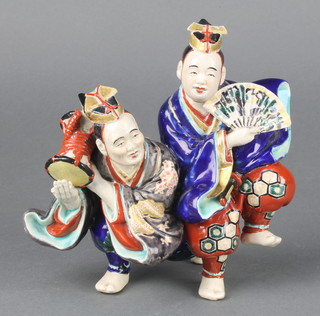 An early 20th Century Japanese group of 2 male musicians with coloured enamels and gilding 6" 