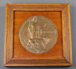 A First World War death plaque to Alfred Staddon contained in an oak frame 