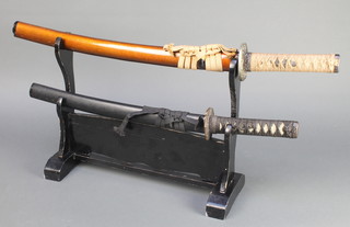 2 reproduction Wakizashi swords, 1 has a 20 1/2" blade the other 17" blade, complete with a lacquered stand 