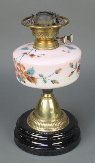 A Victorian pink opaque glass oil lamp reservoir with floral decoration raised on a gilt base 13"  