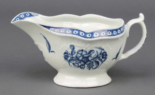 An 18th Century Worcester blue and white sauce boat with strap, fluted floral decoration 6" 