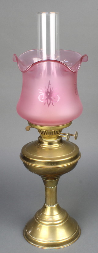 A brass oil lamp with clear glass chimney and etched glass shade 23"h  