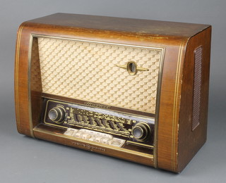 A Loewe Opta radio contained in a walnut finished case