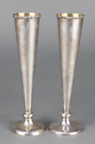 A pair of silver table posy vases with rubbed marks 8" 
