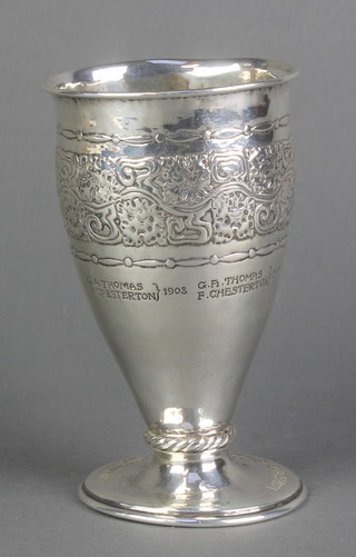 An Arts & Crafts silver beaker with repousse decoration and presentation inscription, maker  Ramsden & Carr London 1906 5", 138 grams 