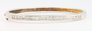 A silver bangle of plain form set with paste stones, 14 grams 
