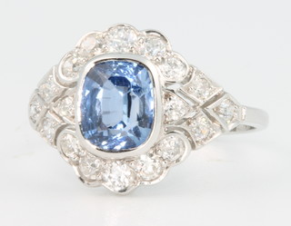 An 18ct white gold sapphire and diamond ring, the centre stone approx 0.75ct surrounded by brilliant cut diamonds approx. 1.50ct, size N