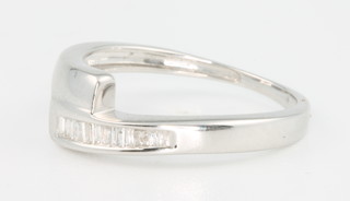A 9ct white gold diamond ring set with tapered baguette cut stones, size J 