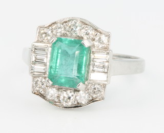 An 18ct white gold emerald and diamond  Art Deco style ring, the centre octagonal cut stone approx 1.85ct flanked by baguette and brilliant cut diamonds approx. 0.9ct size O  