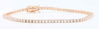 An 18ct rose gold diamond tennis bracelet set with 83 brilliant cut diamonds  