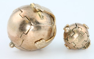 Two 9ct yellow gold Masonic ball pendants with silver centres.