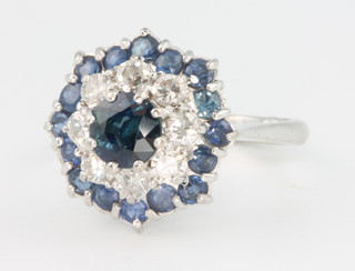 An 18ct white gold sapphire and diamond cluster ring, size I