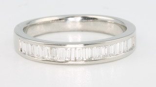 A platinum and baguette diamond half eternity ring, approx. 0.5ct, size P 1/2