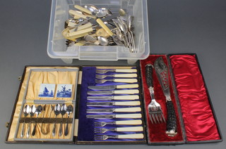 A pair of silver plated cased fish servers and minor plated cutlery, a pair of silver nips and a butter knife 
