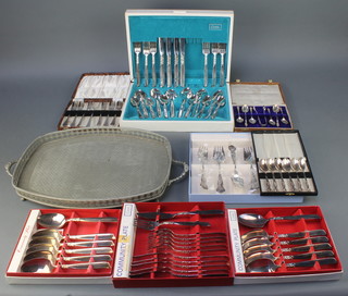 A silver plated 2 handled tray and a quantity of cased sets