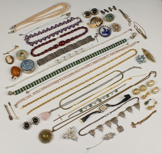 An amber brooch, a lady's wristwatch, brooches, necklaces and minor costume jewellery