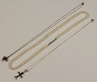 A silver cross and chain, a pendant and chain and a string of imitation pearls