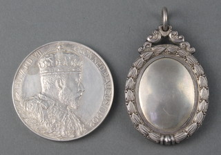 A silver medallion and a commemorative crown