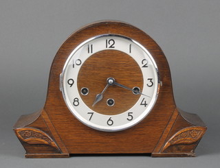 An Art Deco Haller chiming mantel clock with silvered dial and Arabic numerals contained in an oak arch shaped case  