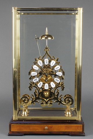 A Victorian style skeleton clock with Arabic  numerals contained in a gilt metal framed glazed case, raised on a walnut finished base fitted a drawer, 22 1/2"h x 12"w x 8 1/2d 