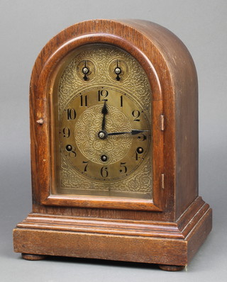 An Edwardian German chiming bracket clock with 6" arched gilt dial and Arabic numerals contained in an oak case 