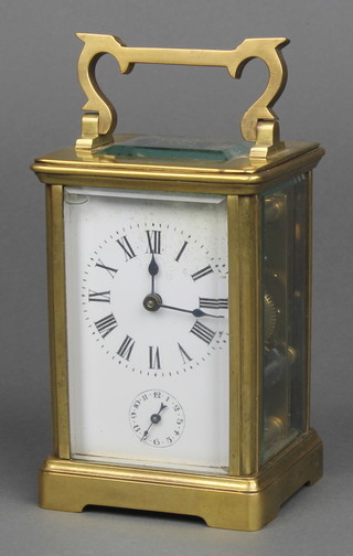 A French 19th Century carriage alarm clock with enamelled dial and Arabic numerals contained in a gilt metal case 