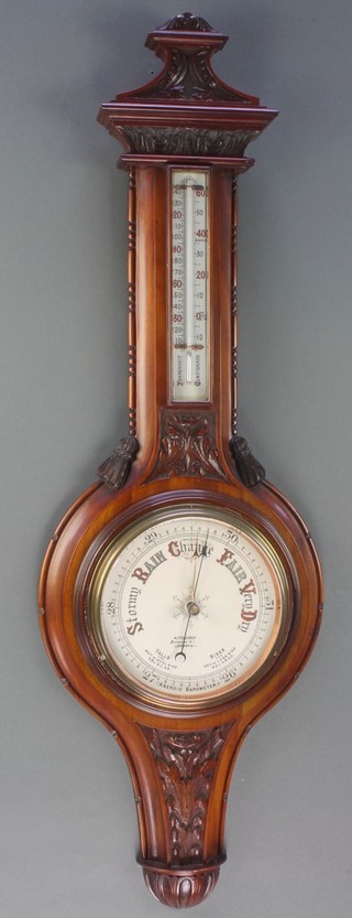 An Edwardian aneroid barometer and thermometer with porcelain dial, contained in a carved walnut case, the dial marked Aitchison 