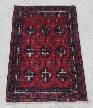 A red and blue ground Belouch rug with 9 octagons to the centre 57" x 36" 