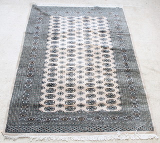 A sand ground Bokhara carpet with 84 octagons to the centre within a multi-row border 100" x 74" 