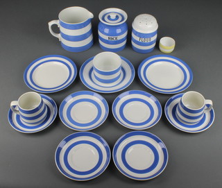 A quantity of Green & Co tableware comprising 2 coffee cups, 6 saucers, 3 small plates, a table salt, a shaker, a jug and a rice jar and lid 
