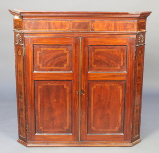 A 19th Century inlaid mahogany hanging corner cabinet with moulded cornice, enclosed by panelled doors 40 1/2"h x 40"w x 23 1/2"d 