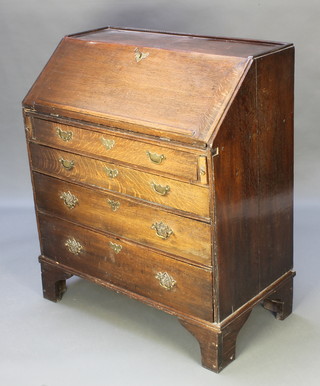 A Georgian oak bureau with fall front revealing a well fitted interior above 4 long graduated drawers, raised on bracket feet  42"h x 36"w x 19 1/2"d 
