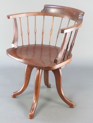 An Edwardian mahogany stick and bar back revolving office chair